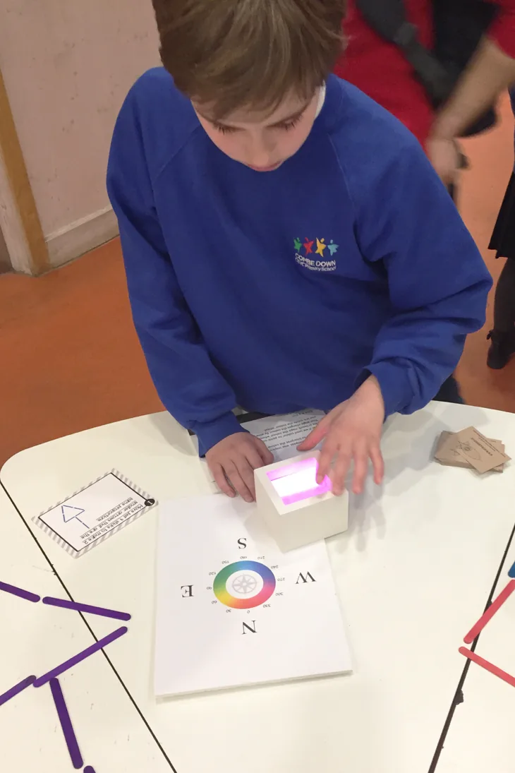 Boy playing with light compass